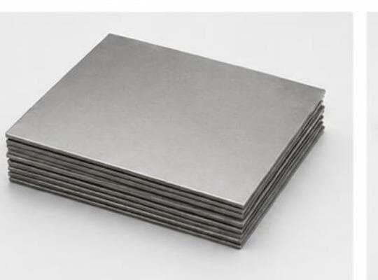 Stack of machined titanium plate stock for implant blanks.