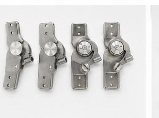 Machined knee hinge implant assemblies with stainless steel pivot pins.